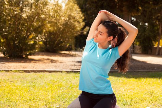 young beautiful woman stretching after sport outdoors