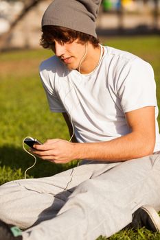 young handsome man consulting phone outdoors