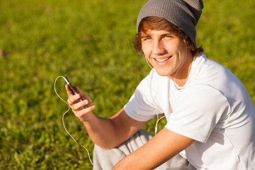 young handsome man consulting phone outdoors