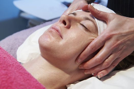 woman having a facial treatment in beauty salon