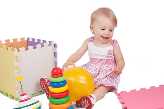 Baby girl playing toys over white