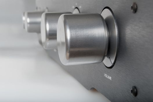 Volume Knob on Silver Metallic Amplifier - Shallow Depth of Field