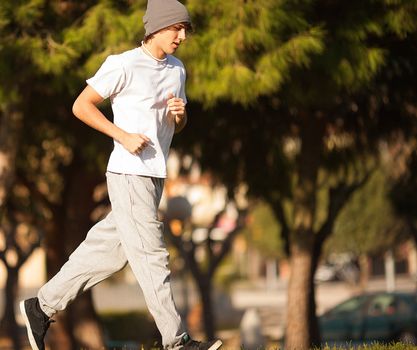 young handsome man jogging in public park