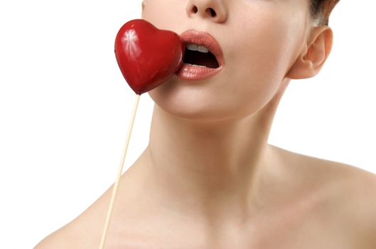 Beautiful woman kissing red heart. Face closeup. Isolated on white background