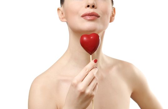 Beautiful woman holding red heart. Face closeup. Isolated on white background