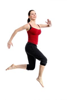 Girl in sportswear jumping jumping over white background. Isolated.