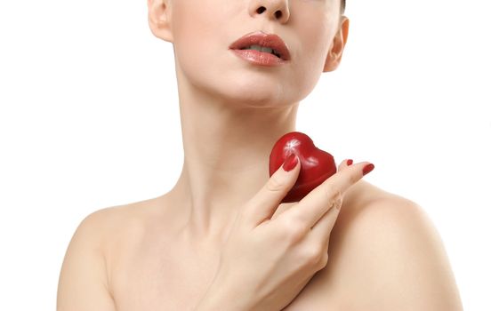 Beautiful woman holding red heart. Face closeup. Isolated on white background