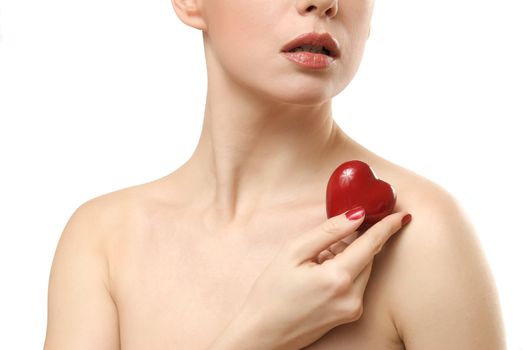 Young woman showing small heart. Isolated on white background