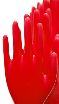 Row of red latex gloves on white background