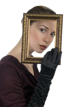 Young woman looking through picture frame