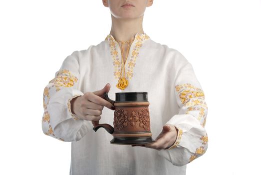 Woman's hand holding beer mug. Traditional ukranian dress. Isolated on white