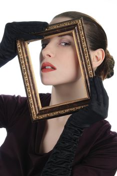 Young woman looking through picture frame