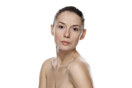 Portrait of young beautiful serene girl with healthy complexion. Isolated on white background