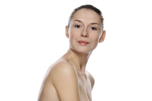 Portrait of young beautiful serene girl with healthy complexion. Isolated on white background