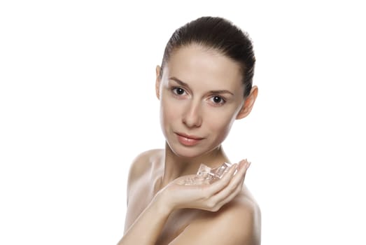 Portrait of young beautiful girl holding ice cubes. Isolated on white background