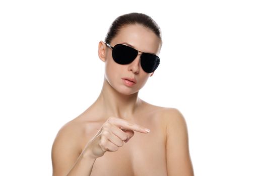 Portrait of glamour woman in sunglasses. Shows the left. Isolated on white background. Small depth of field.