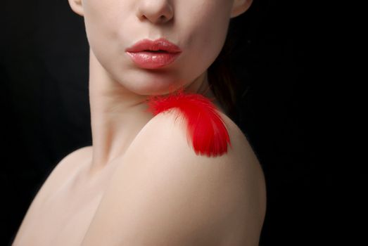 Young topless woman blowing a plume