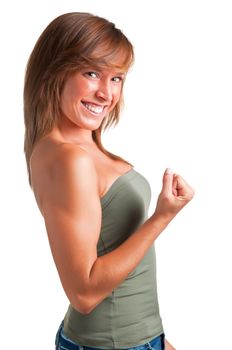 Young brunette smiling and flexing her bicep in a sign of victory, isolated in a white background