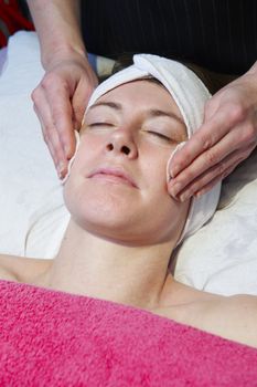 woman having a facial treatment in beauty salon