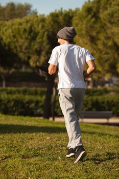 young handsome man jogging in public park