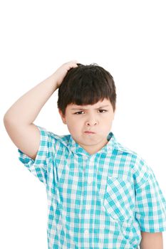 Boy scratches his head in puzzlement or confusion, as if pondering a deep question. Over white background.