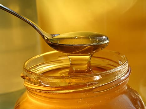spoon scooping honey from jar