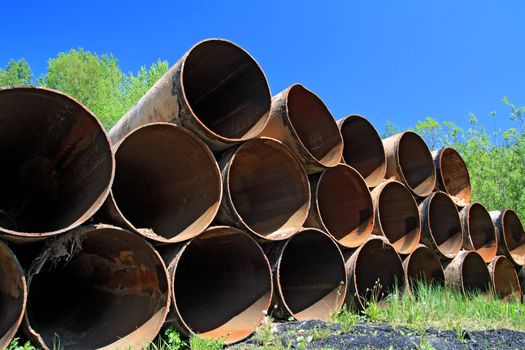 old gas pipes amongst green herb