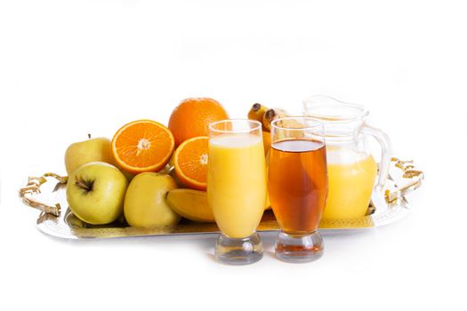 Apple and orange fruits with juice on tray over white
