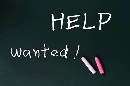 Help wanted - written with chalk on a green chalkboard background