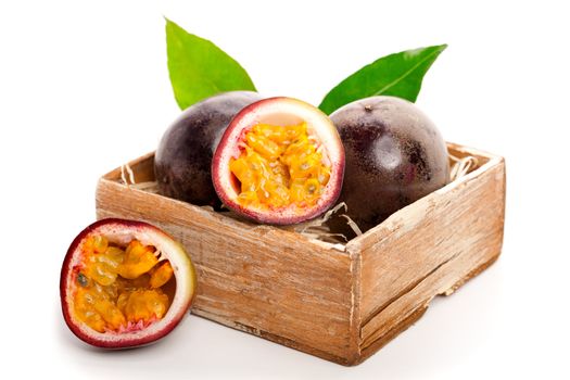 Fresh passion fruit with green leaves isolated on a white background