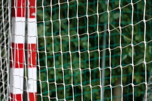 detail of a handball goal with red and white stripes