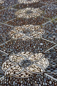 Intricate pathway of an Asian stone mosaic patio