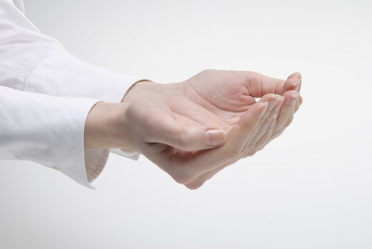 Woman's hand showing support symbol over light background