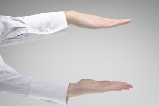 Woman's hand showing  symbol height over light background