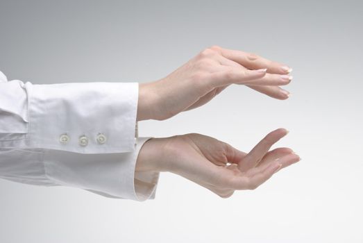 Woman's hand showing  symbol small over light background