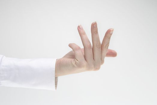 Woman's hand making gesture light background