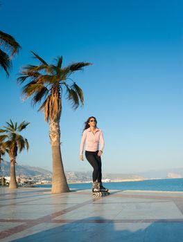 Woman enjoying a sunny afternoon on a beach promenade
