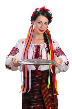 Young Ukrainian woman in national costume holding epmty tray. Isolated on white background