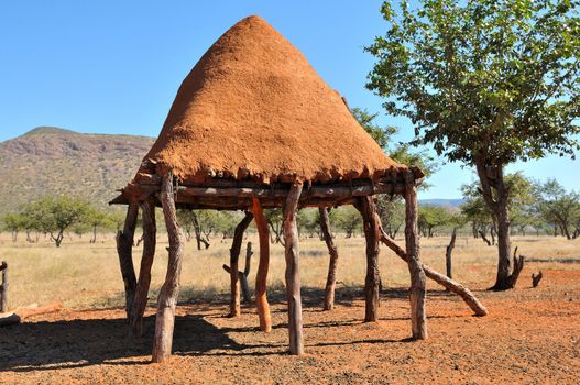 Ovahimba food storage room on stilts to keep food away from domestic animals near Epupa, Namibia. Roof made from mud mixed with dung.