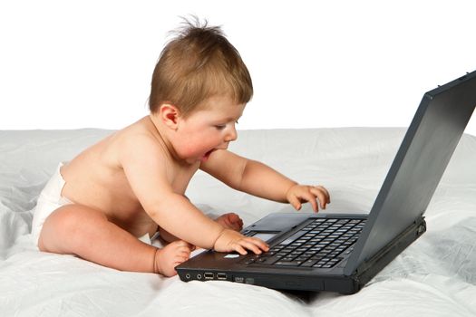 Child playing with  a laptop