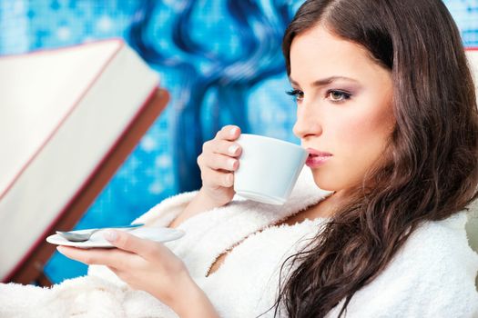 Woman enjoy cup of coffee in spa center