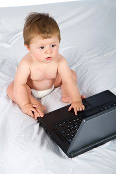 Child playing with  a laptop