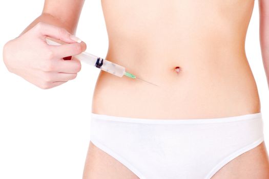 Syringe on woman's stomach, isolated on white. Health concept