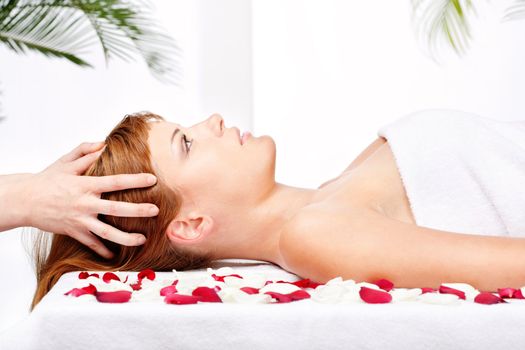 Pretty woman on head massage treatment in salon