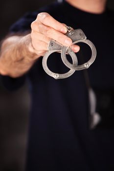 Handcuffs in male officer's hand