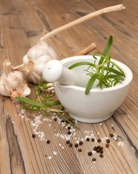 Mortar and Pestle With Ingredients - Rosemary, Salt, Pepper and Garlic