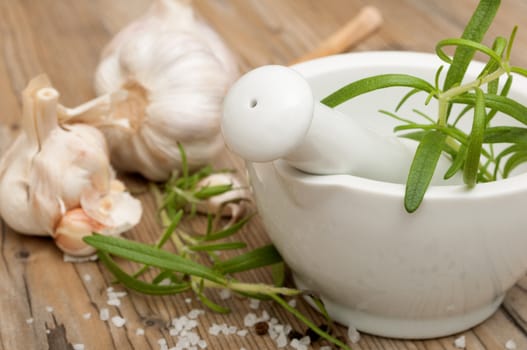 Mortar and Pestle With Ingredients - Rosemary, Salt, Pepper and Garlic
