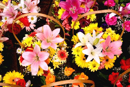 Beautiful bouquets of colorful  flowers in wicker baskets.