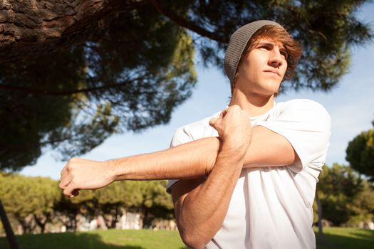 young man portrait stretching after jogging