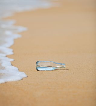 An empty bottle on the beach